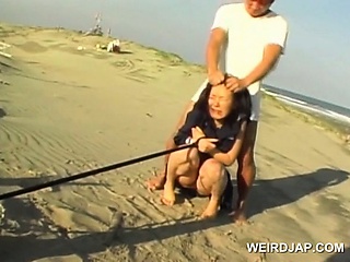 Jap School Babe Held Slave Pissing On The Beach...