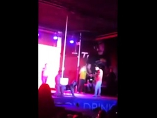 Girl on stage by stripper...
