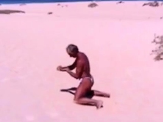 Tanned guy on beach in tiny string thong (temporarily!)