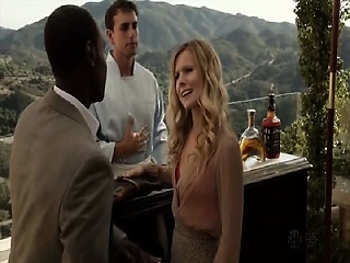 Kristen Bell making out with a man whereas undressing and