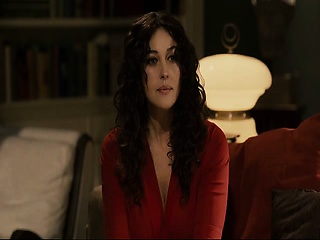 Monica Bellucci in a skimpy black costume that exhibits a lot