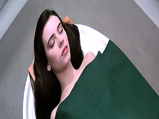 Mathilda Might bare sitting up on a desk, after which standing