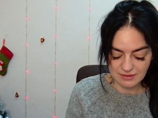 Brunette babe in grey sweater posing