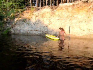Tattooed Babe Strips and Swims on a SUP Board in the Forest